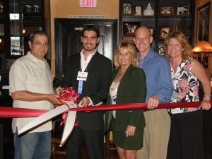 Chamber members conducting a ribbon cutting ceremony.